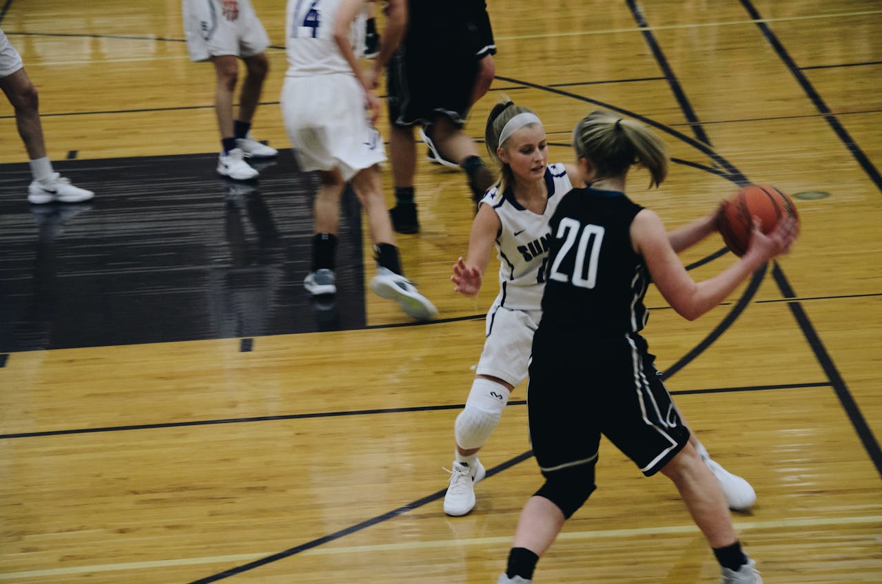 Women basketball , Jersey number 20 holding the ball trying to cross over